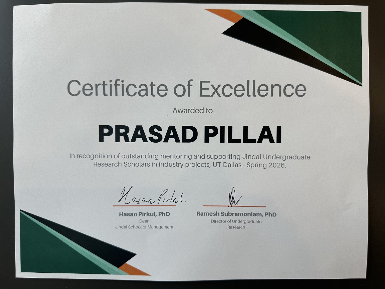 Certificate of Excellence awarded to Prasad Pillai for mentoring and supporting Jindal Undergraduate Research Scholars in industry projects, Spring 2026 — signed by Dean Hasan Pirkul and Ramesh Subramoniam.